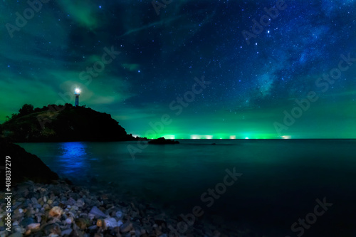 Long exposure photos. Lighthouse Star and the Milky Way at Lanta Island, Krabi Province, Thailand. © Thirawatana