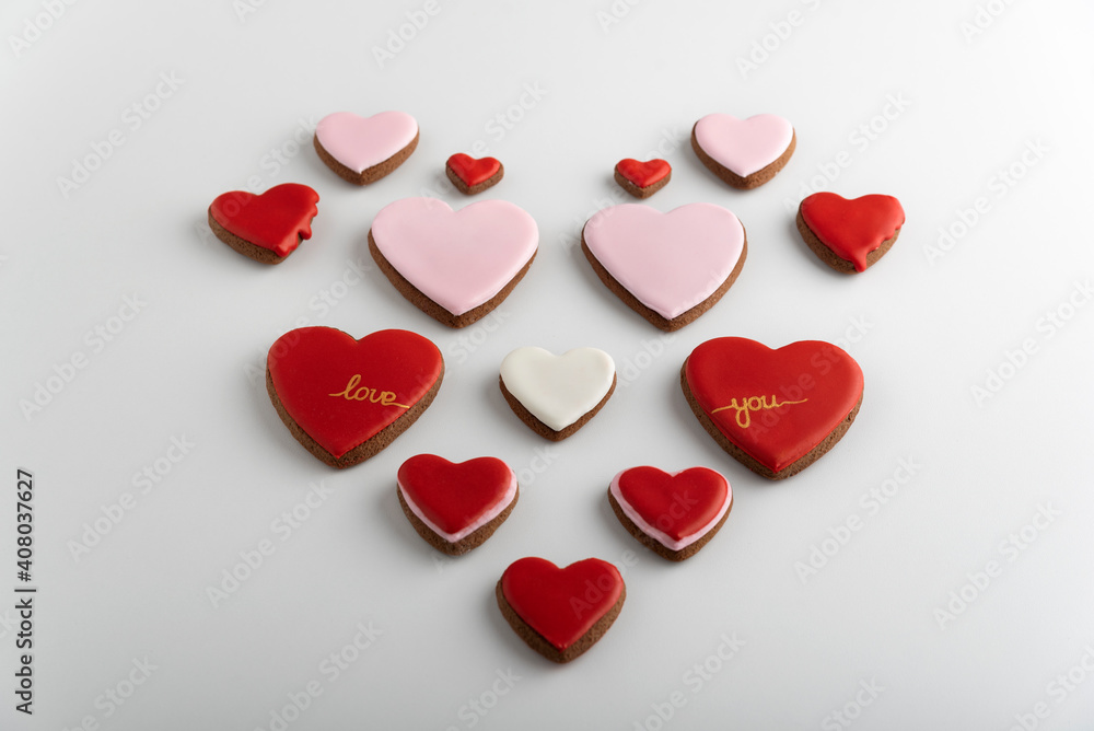 Heart-shaped cookies with colored sugar icing. White background. Valentines day. Heart-shaped cookies with colored sugar icing. White background. Valentines day.