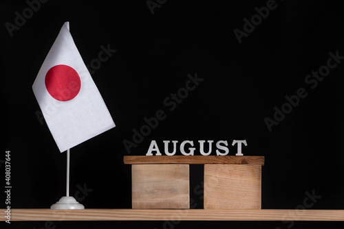 Wooden calendar of August with Japan flag on black background. Dates of Japan in August