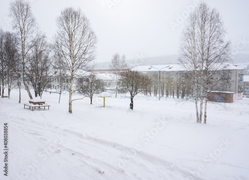 Residential buildings during a snowfall in the working and mining village of Belogorsk. Kemerovo region. Russia.