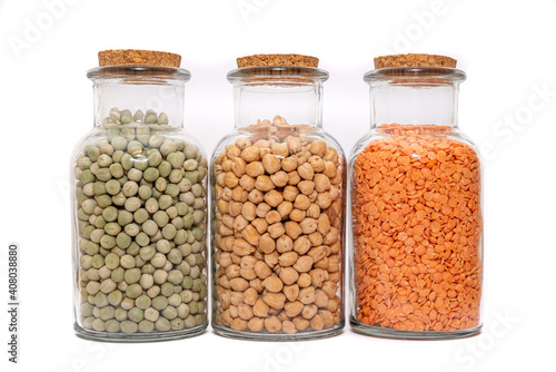 Dried Soup Mix, Split Lentils, Green Peas and Chickpeas. Dried and stored in glass bottles, Isolated against a white background. Preserved in jars. Three nutritious ingredients.