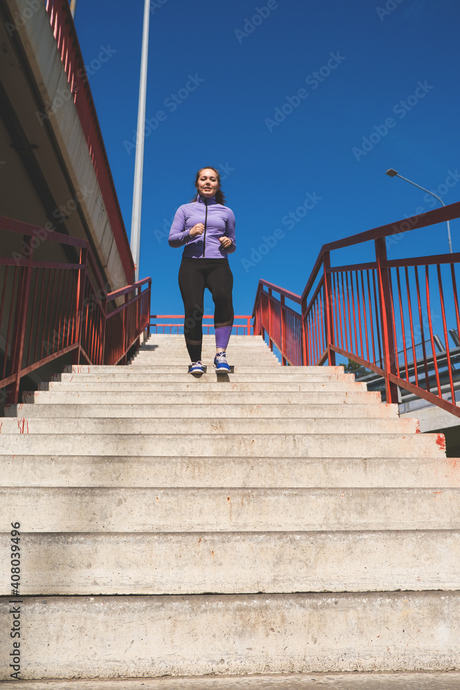 young woman running on the stairs, sport concept young woman running on the stairs, sport concept