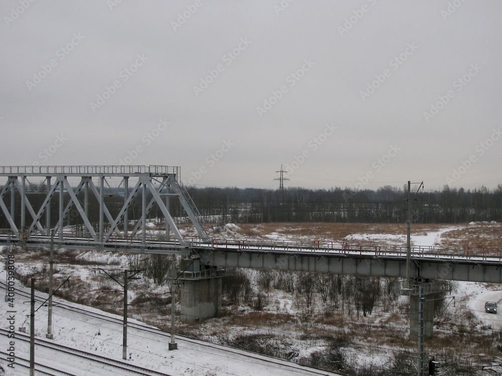 An empty railway on a winter cloudy day. Bridge.