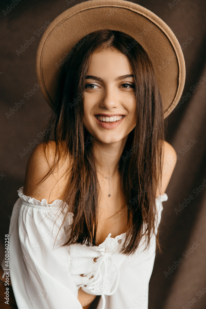 Portrait of happy teenager girl on isolated brown background Portrait of happy teenager girl on isolated brown background