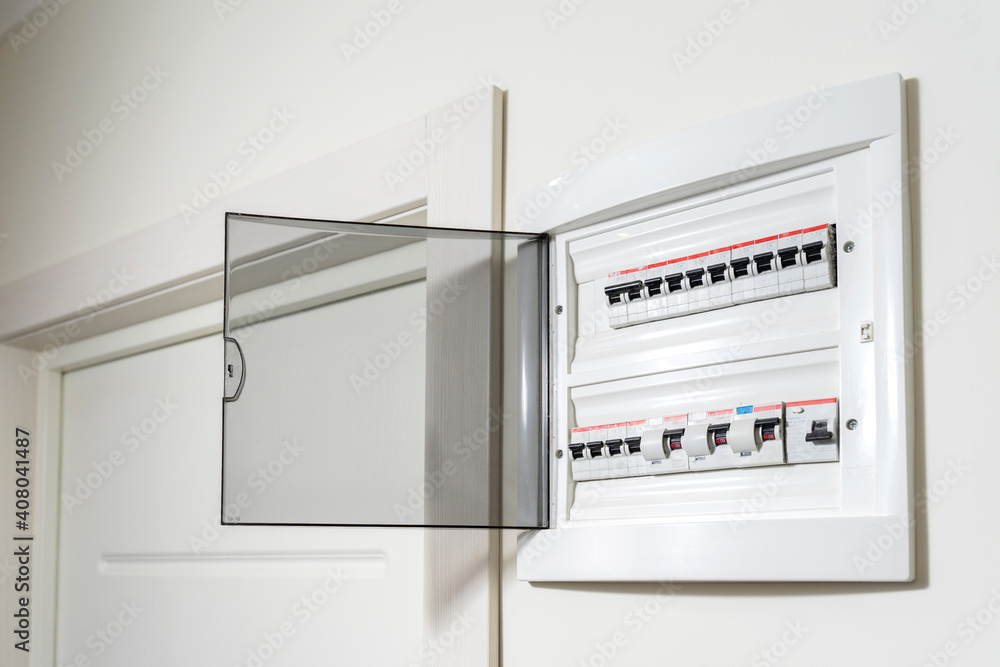 electrical panel in the apartment on a white wall. Fuse box - obrazy, fototapety, plakaty 