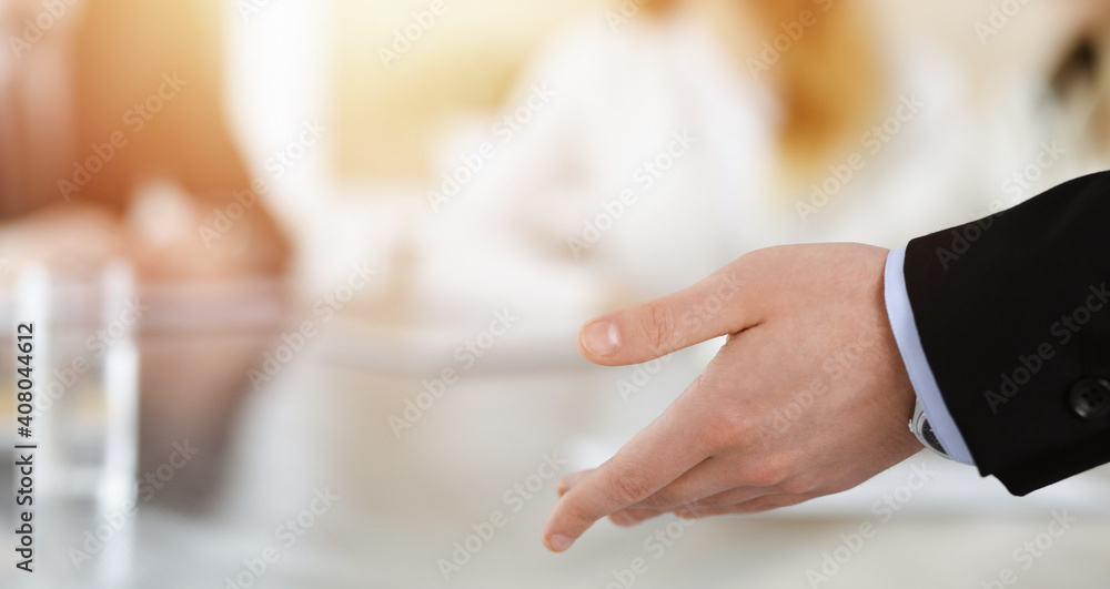 Obraz premium Business presentation. Businessman giving speech to colleagues and partners at corporate meeting or conference, close-up of speaker hands
