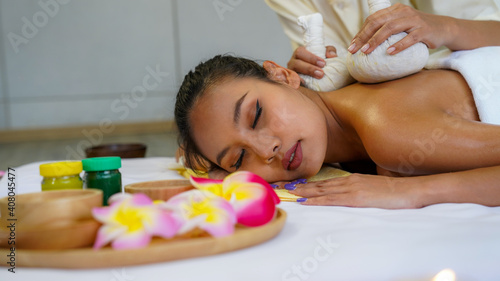 Spa Massage, Thai spa masseuse doing female massage in spa salon