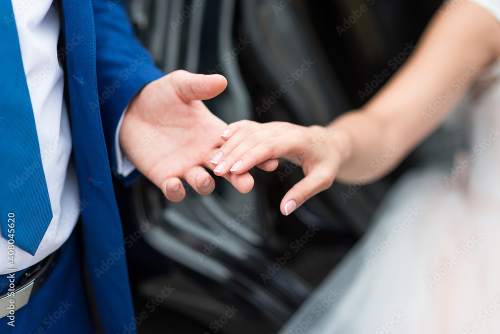 The groom gently touches the bride with his hand