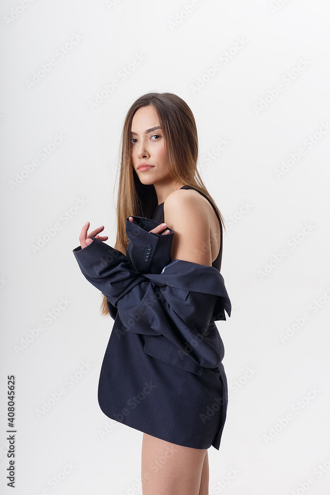 portrait of young attractive asian woman with long hair in black bodysuit and blue suit isolated on white studio background. skinny pretty female posing on cyclorama. model tests of beautiful lady portrait of young attractive asian woman with long hair in black bodysuit and blue suit isolated on white studio background. skinny pretty female posing on cyclorama. model tests of beautiful lady