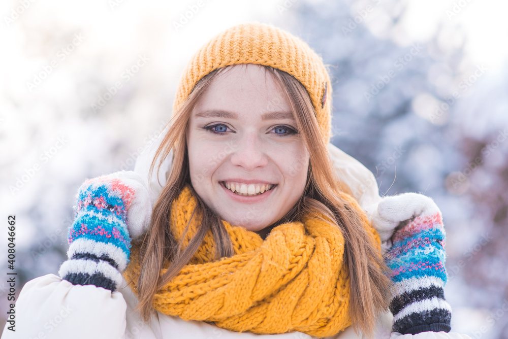 Portrait of a happy smiling girl on a snowy winter day Portrait of a happy smiling girl on a snowy winter day
