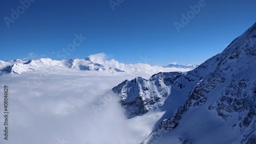 Snowy mountains above the clouds © sjoerd