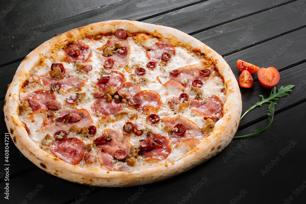 Delicious fresh pizza with meat and sausage on wooden background