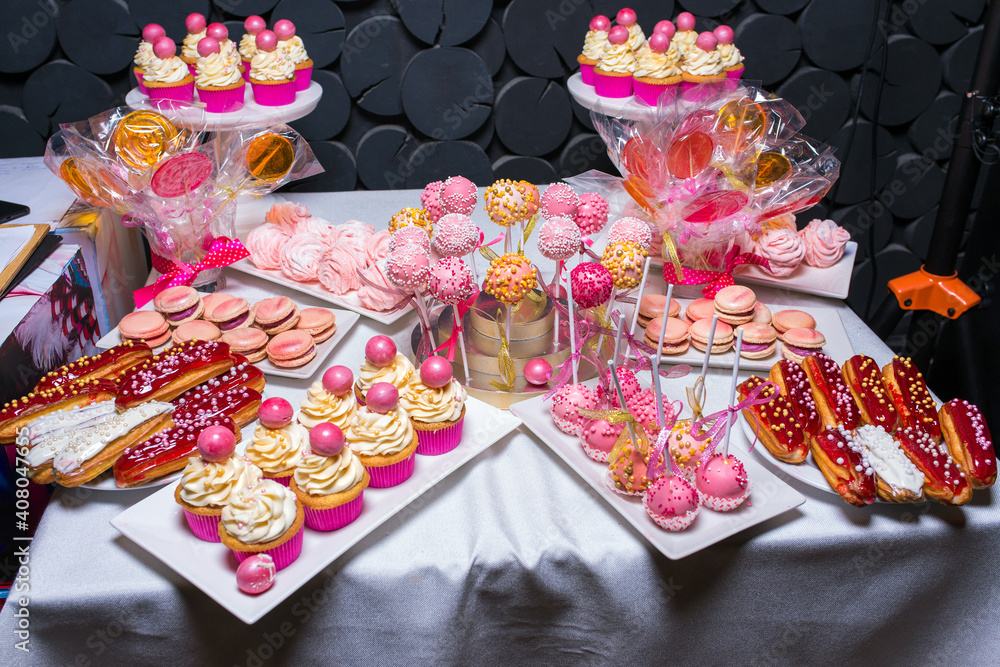 Table with different sweets and cupcakes at a children's party