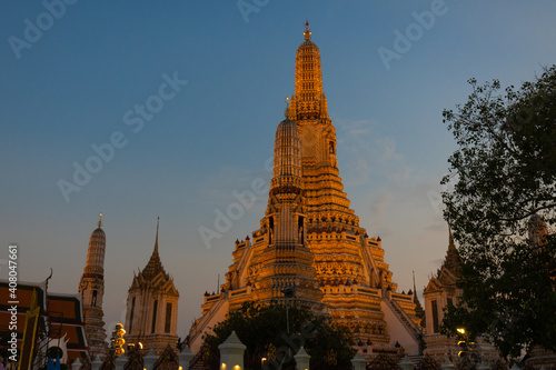 Illuminated Wat Arun Temple in sunset. Buddhist temple in Bangkok, Thailand