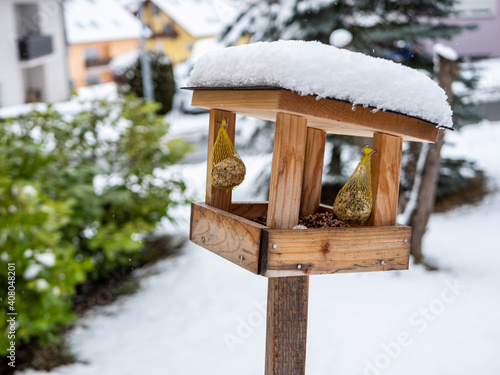 Vogelhaus mit Vogelfutter und Schnee bedeckt 