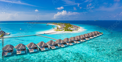 Maldives paradise scenery. Tropical aerial landscape, seascape with long jetty, water villas with amazing sea and lagoon beach, tropical nature. Exotic tourism destination banner, summer vacation © icemanphotos