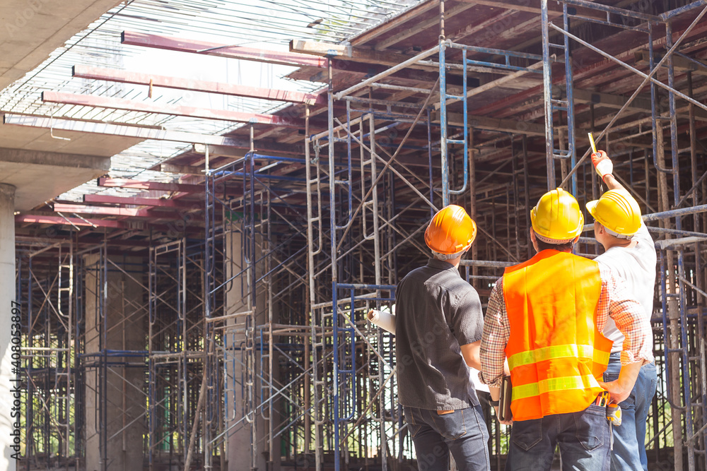 construction engineer who looks after the progress of a construction project stands on the concrete floor.