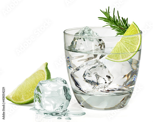 Rosemary infused vodka or gin with sliced lime and rosemary in glass isolated on white background including clipping path photo