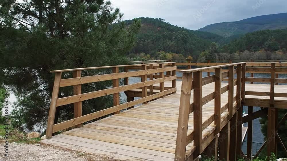Traveling to a wooden viewpoint that overlooks the river jetty Traveling to a wooden viewpoint that overlooks the river jetty