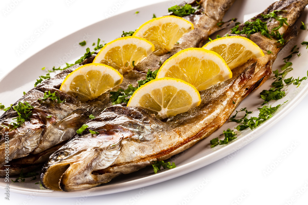 Fish dish - roasted trout with lemon on white background
Fish dish - roasted trout with lemon on white background