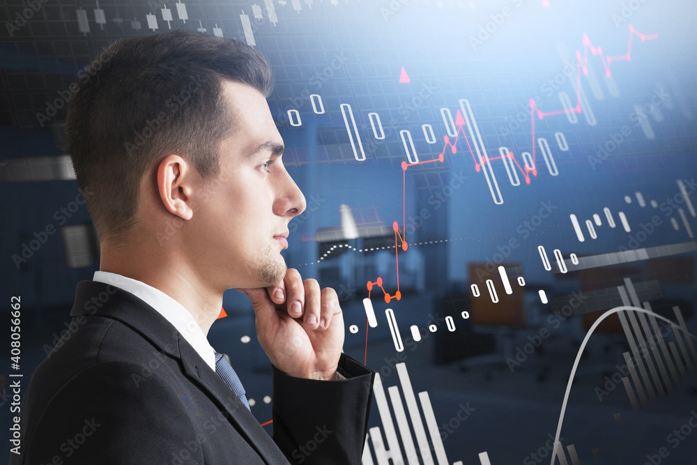 Thoughtful man in blurry office, financial graph Thoughtful man in blurry office, financial graph