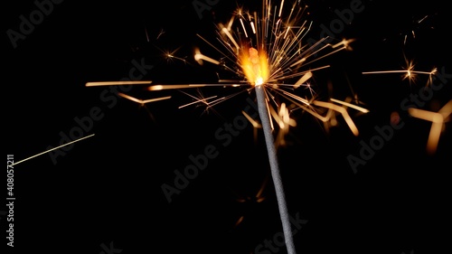 Bengal fire. New year sparkler candle on a black background. Sparkling stars burning. Movie suitable for celebrations  Christmas  Xmas  holidays  birthday party  wedding