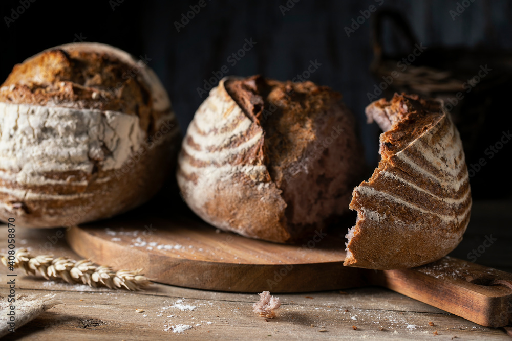 Fresh broken bread on a wooden table Fresh broken bread on a wooden table