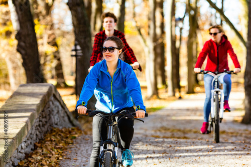 Healthy lifestyle - people riding bicycles in city park 