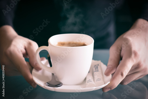 Coffee In Hands With spoon and sugar