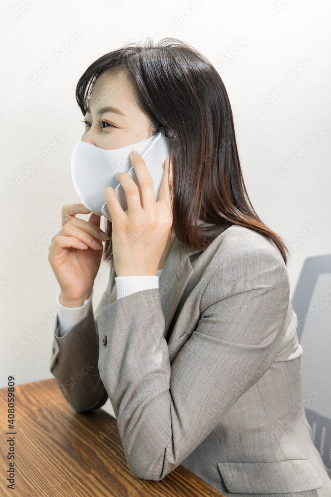 Woman wearing a mask calling for work with a smile Woman wearing a mask calling for work with a smile