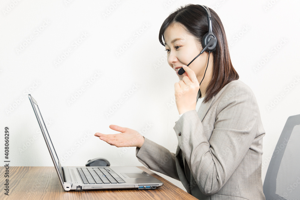 Woman wearing a headset and having a web conference Woman wearing a headset and having a web conference