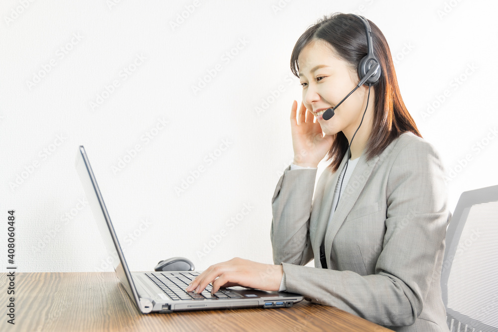 Woman wearing a headset and having a web conference Woman wearing a headset and having a web conference
