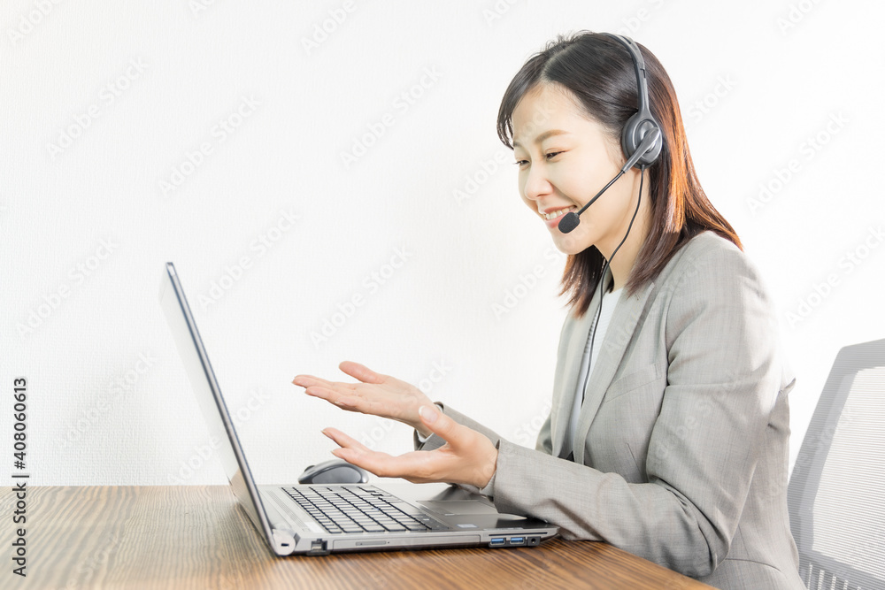 Woman wearing a headset and having a web conference Woman wearing a headset and having a web conference