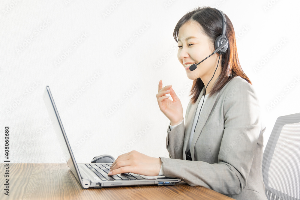 Woman wearing a headset and having a web conference Woman wearing a headset and having a web conference