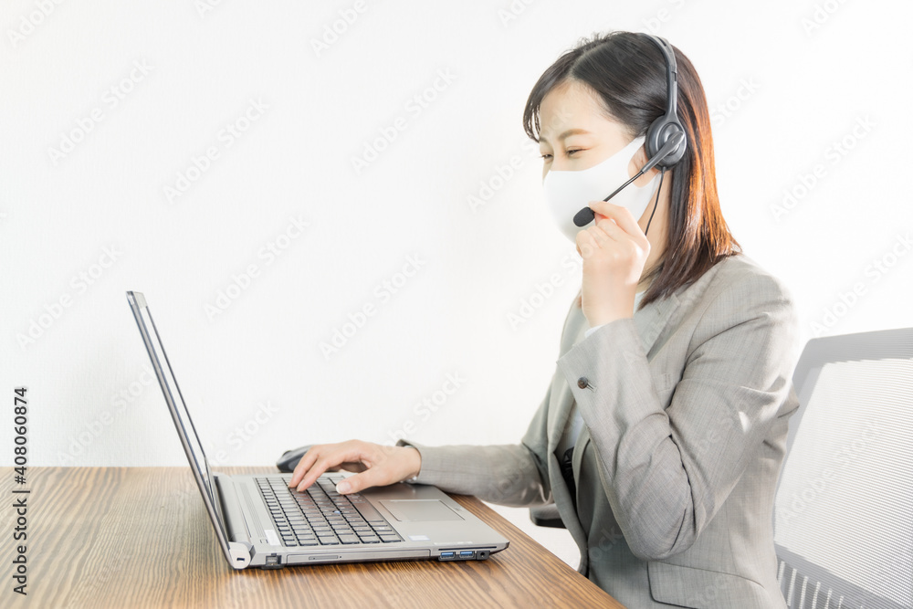 Woman wearing a headset with mask and having a web conference Woman wearing a headset with mask and having a web conference