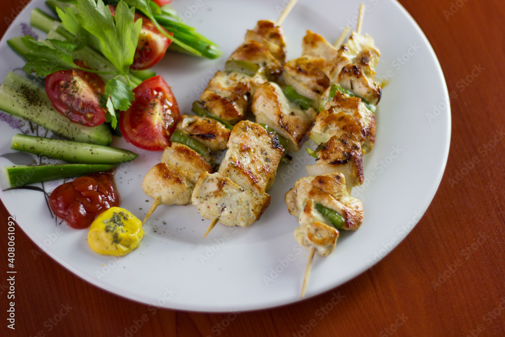 Chicken shish kebab, grilled chicken with greens and tomato Chicken shish kebab, grilled chicken with greens and tomato