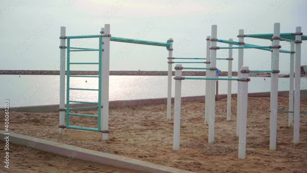 Empty outdoor gym on the beach, deserted during the Covid-19 pandemic lockdown, on a cloudy day Empty outdoor gym on the beach, deserted during the Covid-19 pandemic lockdown, on a cloudy day