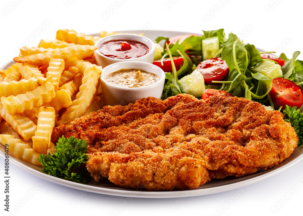 Breaded fried pork chop, French fries and vegetables on white background
Breaded fried pork chop, French fries and vegetables on white background
