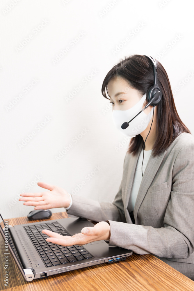 Woman wearing a headset with mask and having a web conference Woman wearing a headset with mask and having a web conference