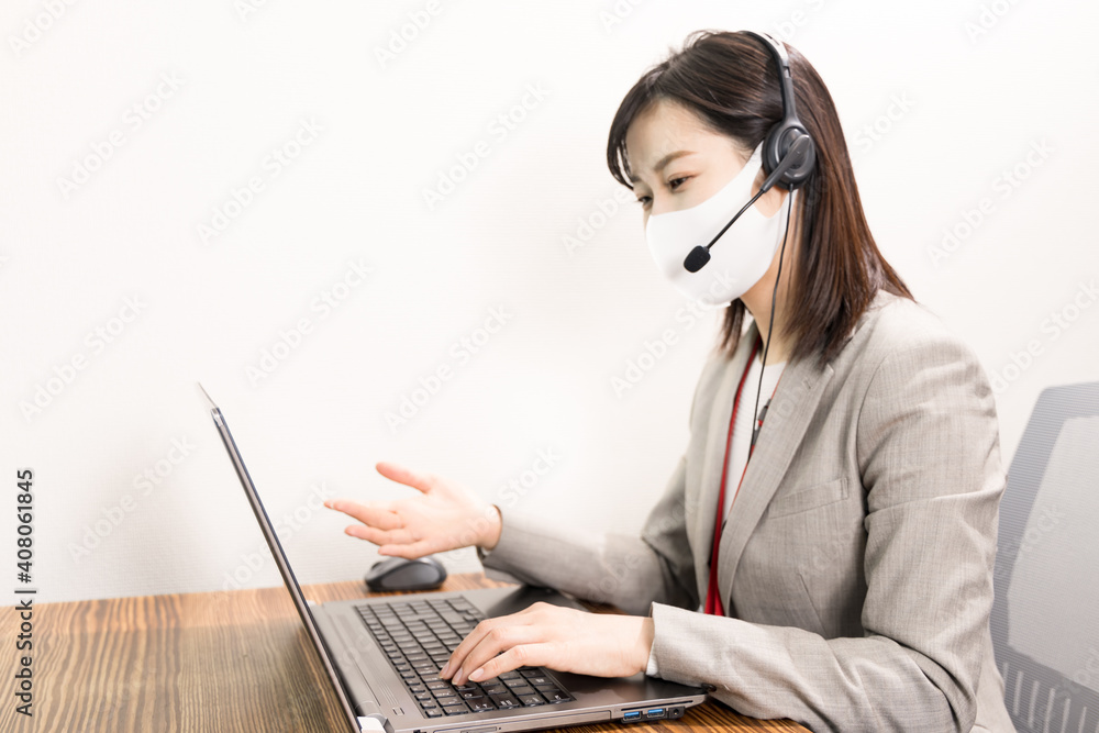 Woman wearing a headset with mask and having a web conference Woman wearing a headset with mask and having a web conference