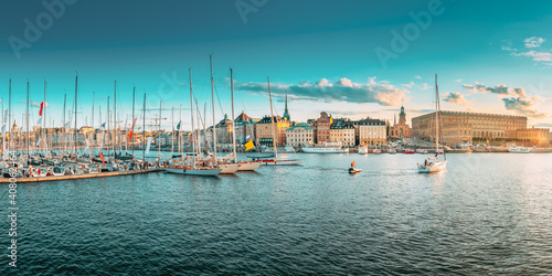 Stockholm, Sweden. Scenic Famous Panoramic View Of Embankment In Old Town Of Stockholm In Sunset Lights. Jetty With Many Moored Yachts. Popular Destination Scenic Place. Panorama