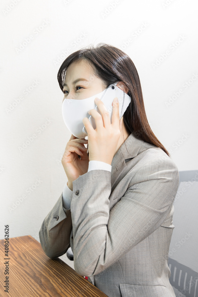 Woman wearing a mask calling for work with a smile Woman wearing a mask calling for work with a smile