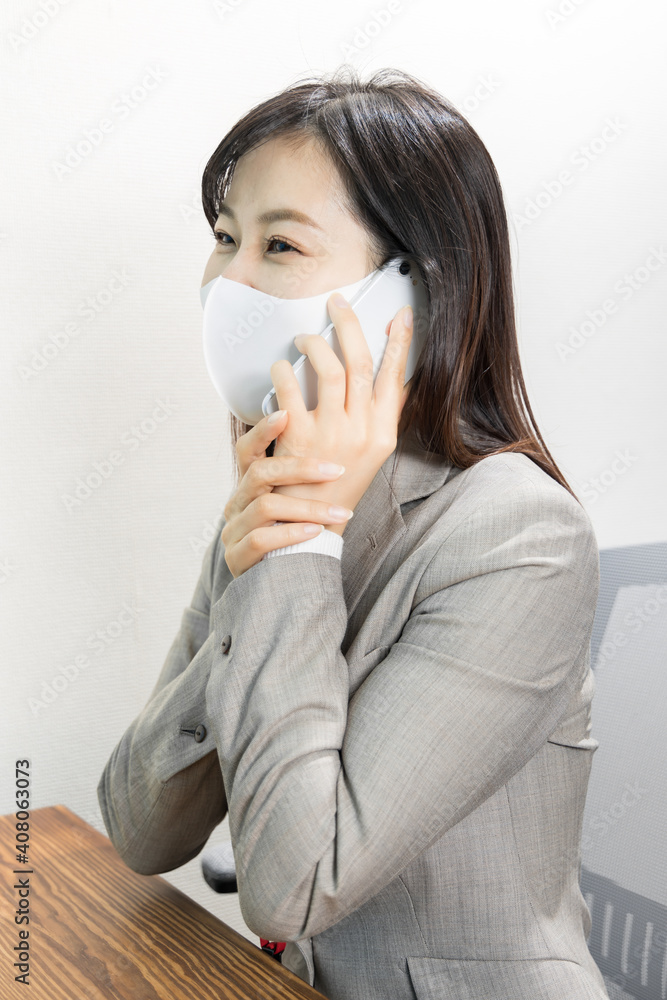 Woman wearing a mask calling for work with a smile Woman wearing a mask calling for work with a smile