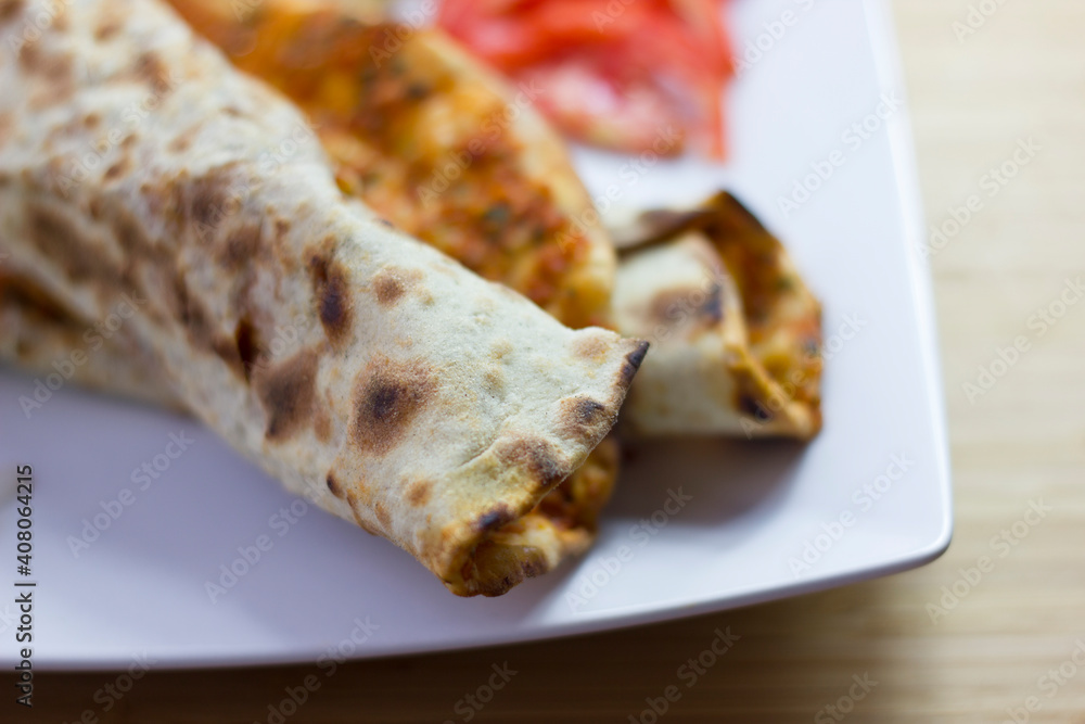 Traditional Turkish pizza (lahmacun) in a white plate