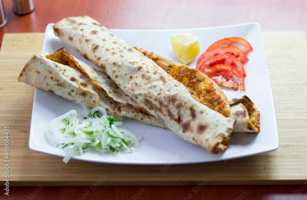 Traditional Turkish pizza (lahmacun) in a white plate Traditional Turkish pizza (lahmacun) in a white plate