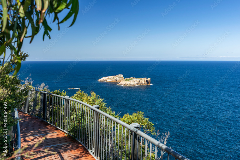 Obraz premium View of The Nuggets, a close group of 4 granite islets, seen from Cape Tourville Lighthouse near the Freycinet Peninsula, East Coast Tasmania, Australia. Penguins and seals are often seen on the rocks