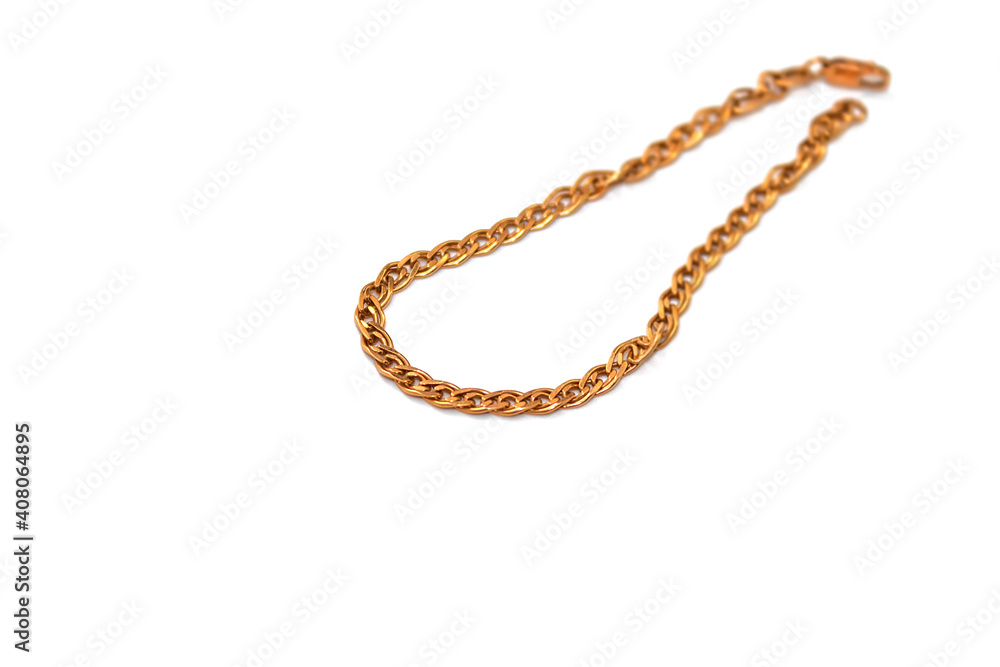 A gold chain for decorating a woman's hand lies on a white background A gold chain for decorating a woman's hand lies on a white background