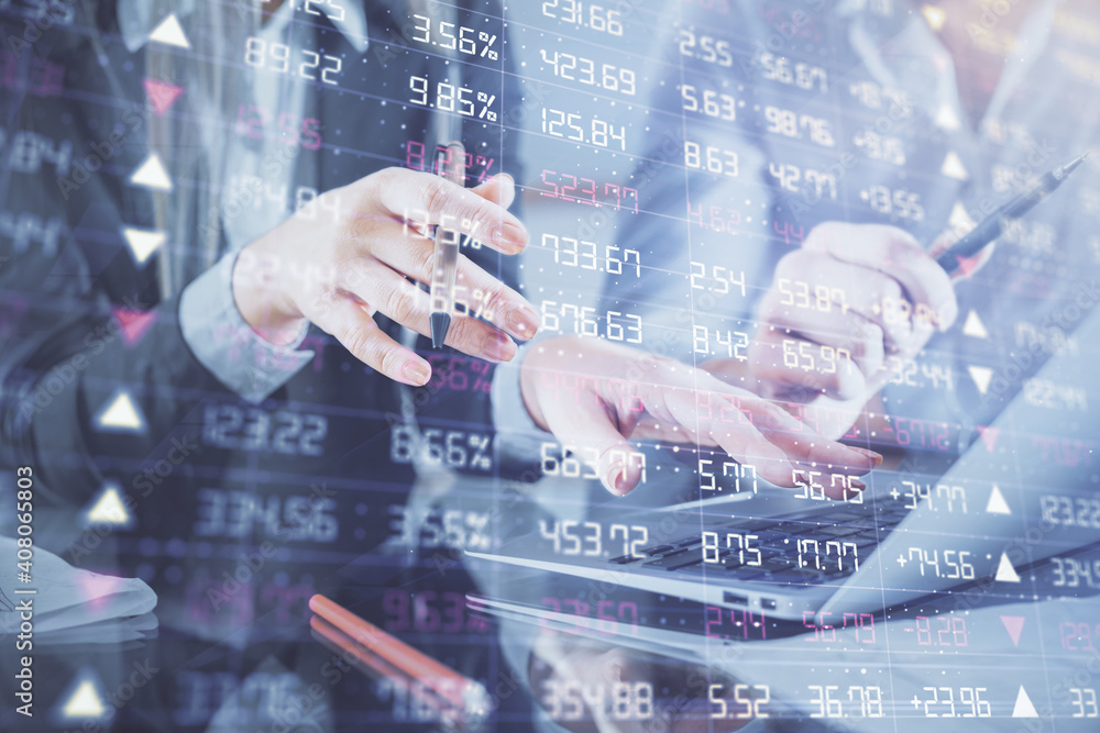 Multi exposure of man and woman working together and financial chart hologram. Business concept. Computer background. Multi exposure of man and woman working together and financial chart hologram. Business concept. Computer background.