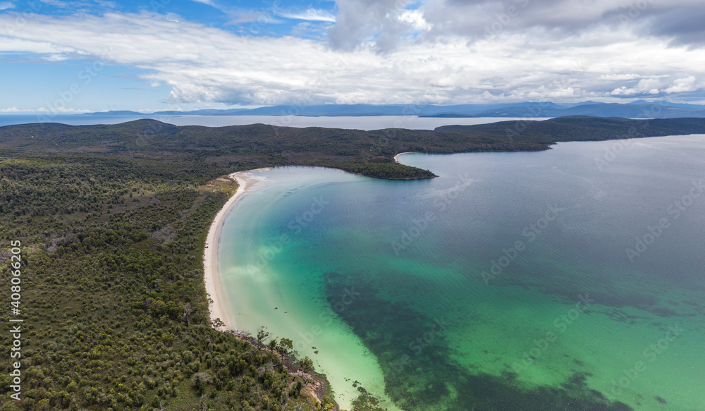 Beautiful high angle aerial drone view of Kingfisher Beach and Jetty Beach in Great Taylors Bay, South Bruny National Park, Bruny Island, Tasmania, Australia. Tasmania mainland in the background.