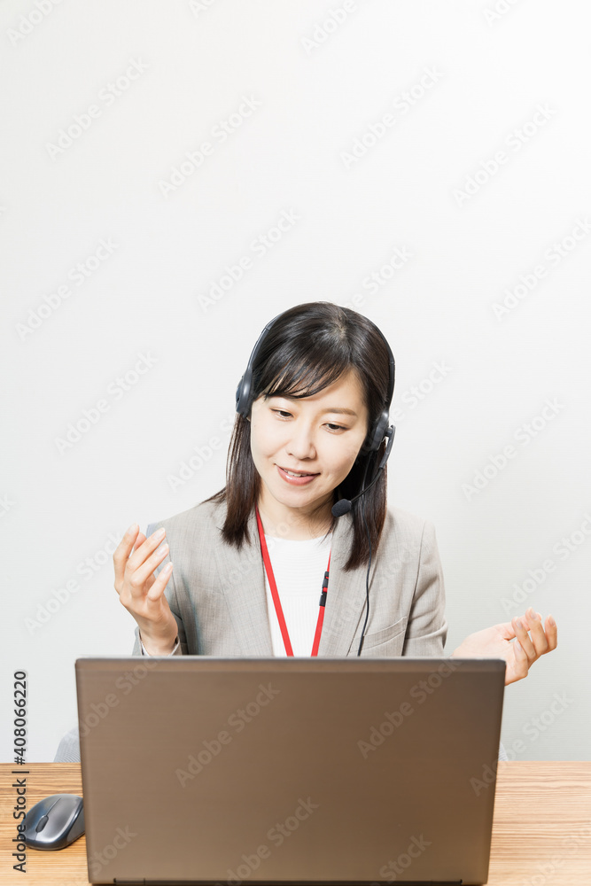 Woman wearing a headset and having a web conference Woman wearing a headset and having a web conference